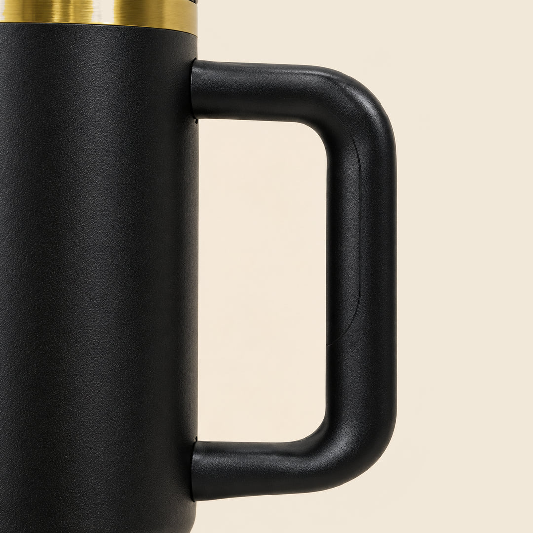 Close detail of the black High Roller tumbler handle, showing its rounded grip and both body attachments.