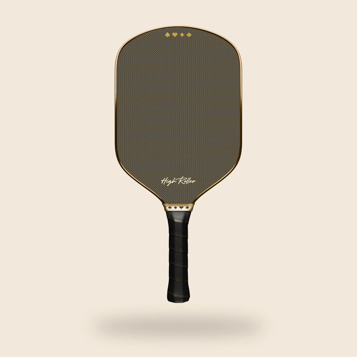 Front view of the High Roller pickleball paddle with gold patterned face, reflective gold perimeter, suit-symbol band and black lettered grip, floating over an off-cream background.