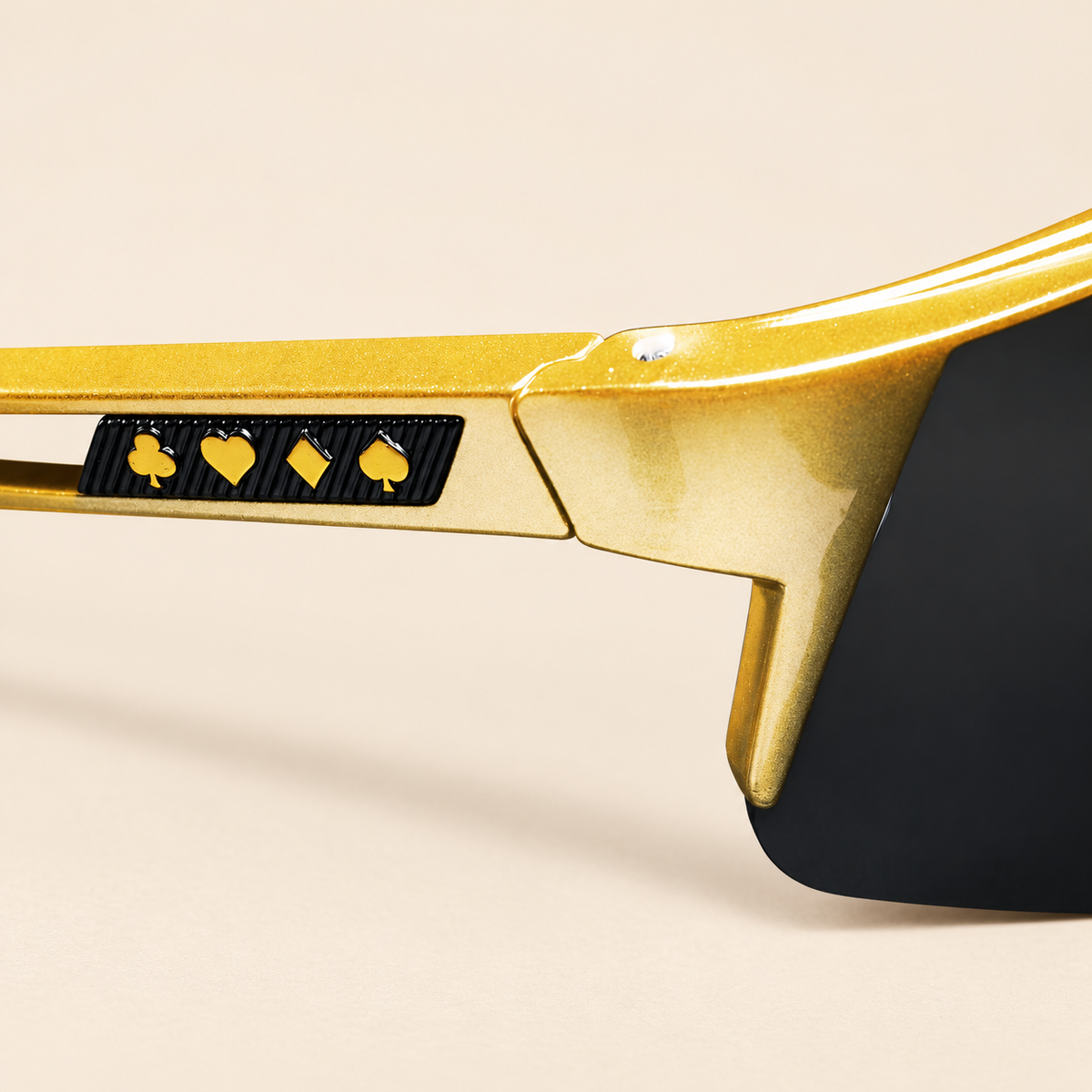 High Roller sunglasses temple with gold club, heart, diamond and spade symbols on a black inset.