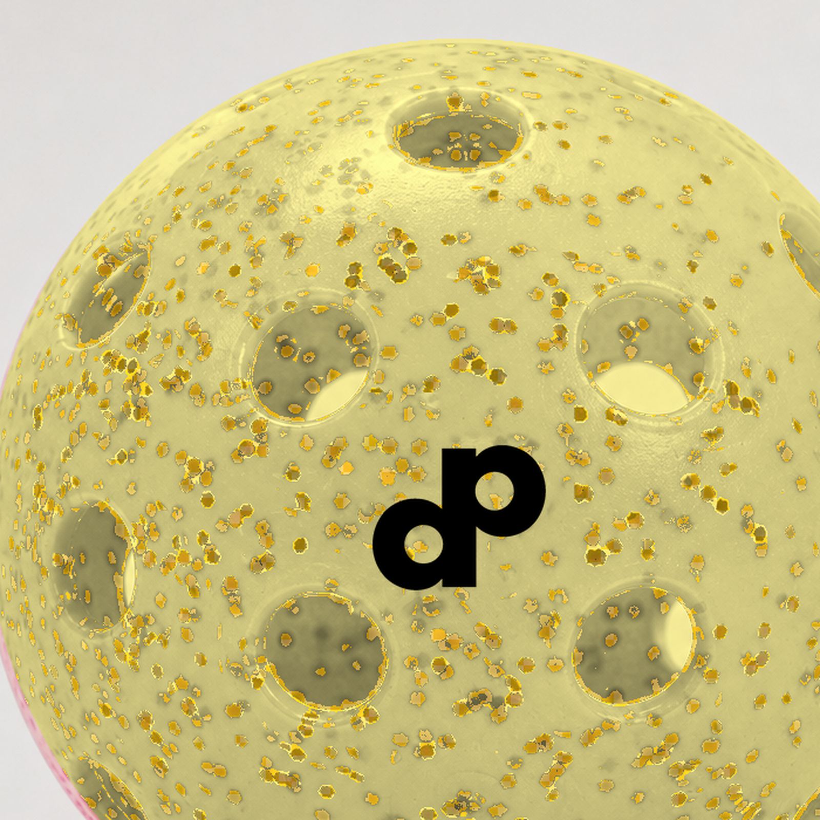 Macro close-up of yellow glitter inside a translucent outdoor pickleball