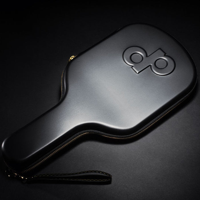 Front of a black High Roller paddle case with an embossed dp logo and wrist strap