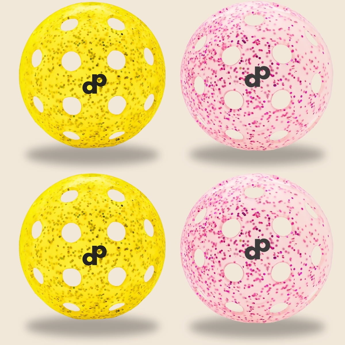 Four pink and yellow glitter-infused pickleballs on a pickleball court