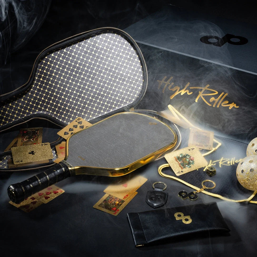 High Roller collection photograph with the metallic chrome-gold paddle, open case, gold-glitter balls and accessories. See the listing for current bundle contents.