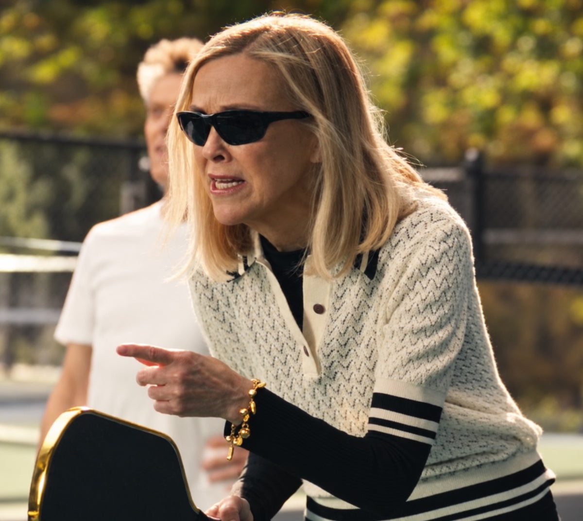 Catherine O’Hara holding the High Roller chrome-gold pickleball paddle in Michelob ULTRA’s Super Bowl commercial; AI-restored film photograph.