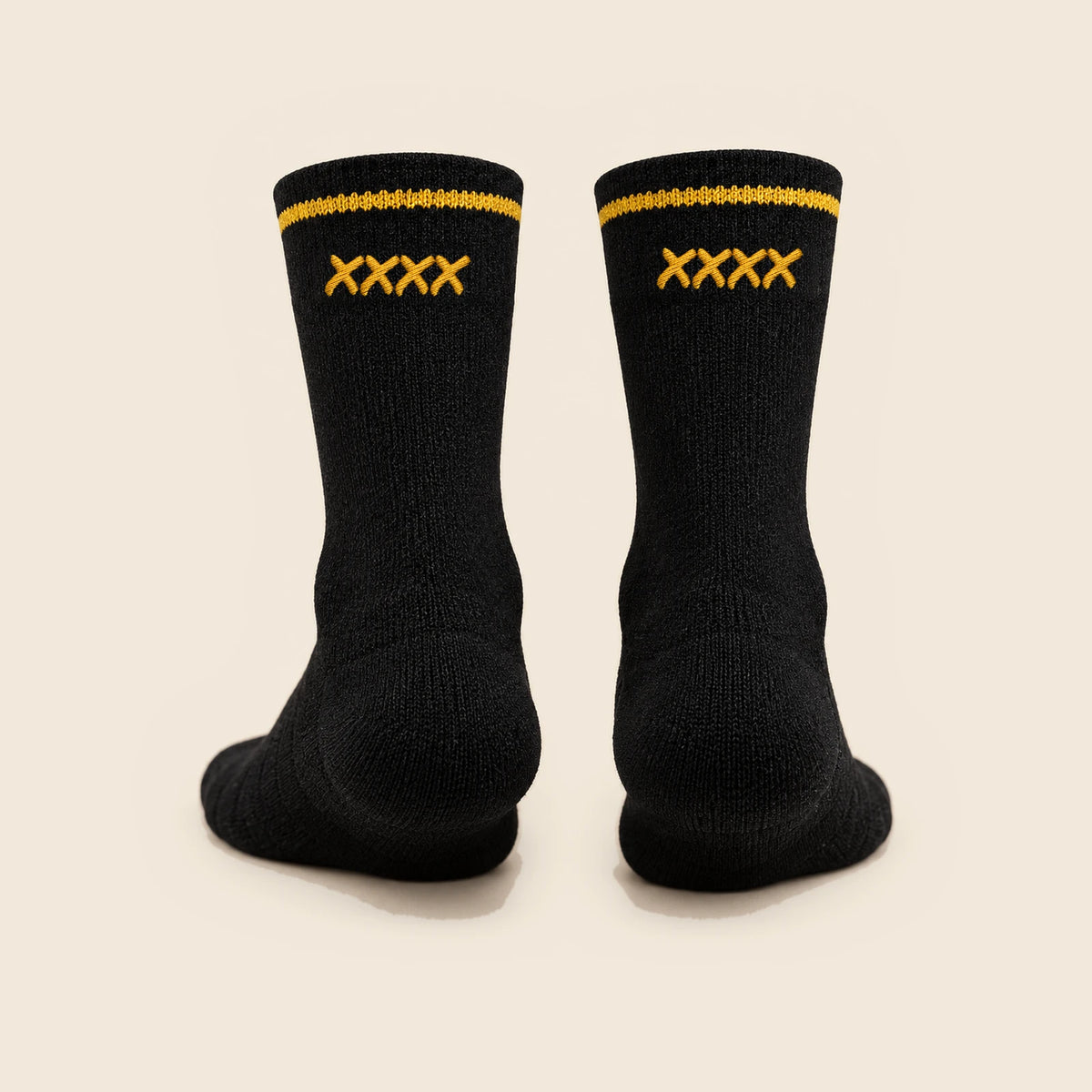 Rear view of black High Roller socks with a single row of four gold stitched x marks beneath each cuff stripe.
