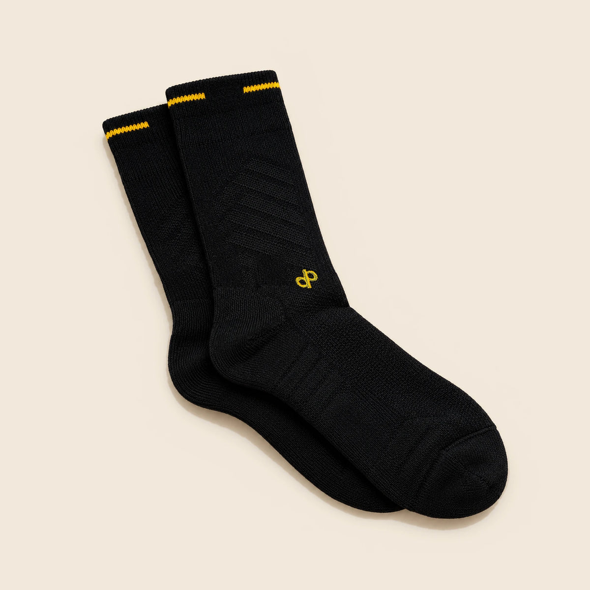 Black High Roller socks with gold DP embroidery at the forward ankle above the instep and a gold cuff stripe.