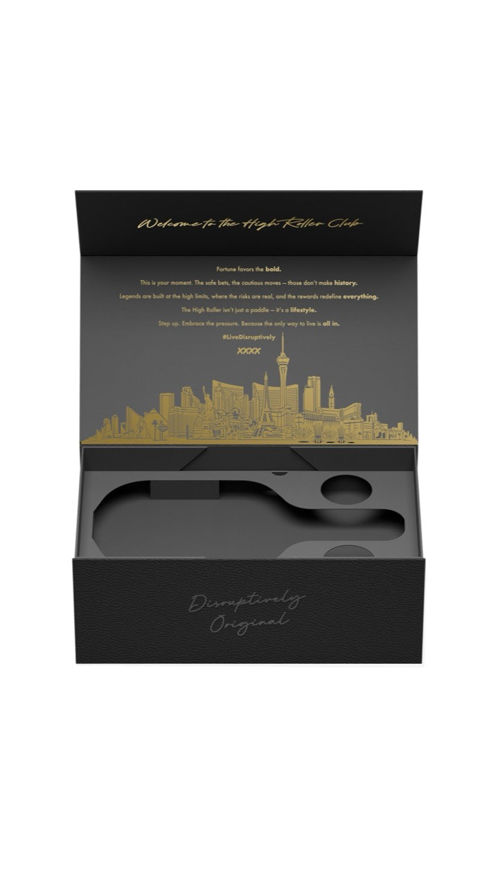Front view of the open black-and-gold High Roller Club presentation box with skyline artwork and fitted insert.
