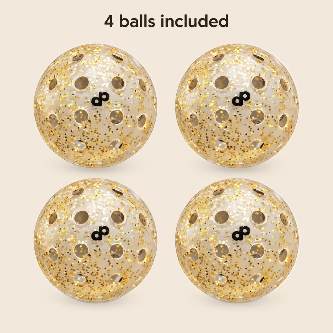 Four translucent High Roller gold-glitter pickleballs with black DP marks, shown on cream with the label 4 balls included.
