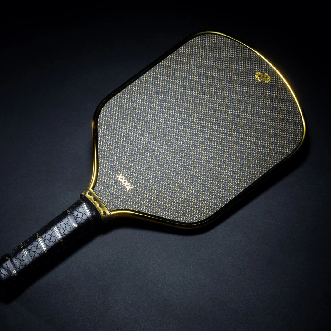 The High Roller paddle's woven face, gold artwork and reflective metallic chrome-gold edge.