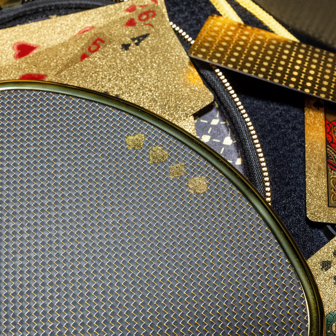 Original photograph of the gold card-suit artwork, woven face and metallic chrome-gold paddle edge.