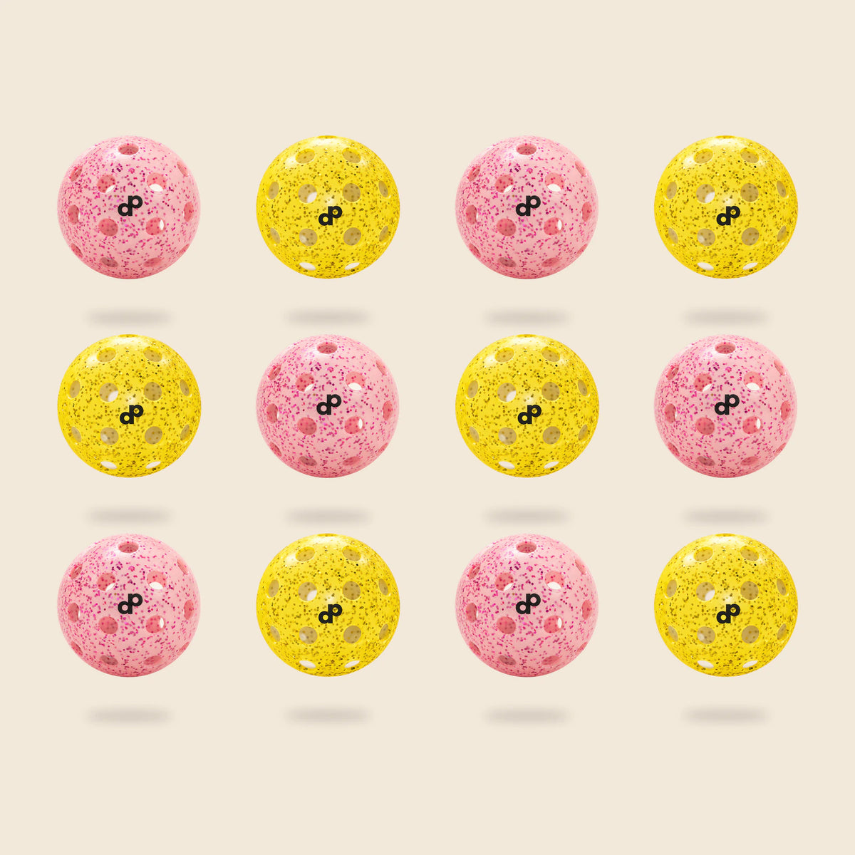 12 DOPE glitter pickleballs, half pink and half yellow, each with a black DP logo, floating on cream.