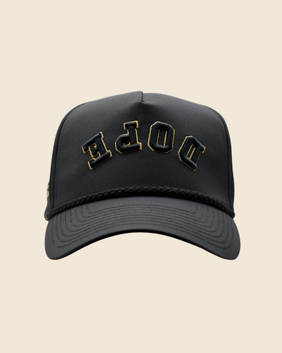 Front view of a black Dope x Reversed hat with gold lettering