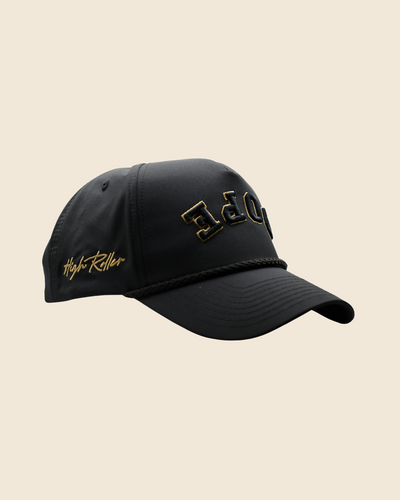 Three-quarter view of a black Dope x Reversed hat with gold lettering and gold side script