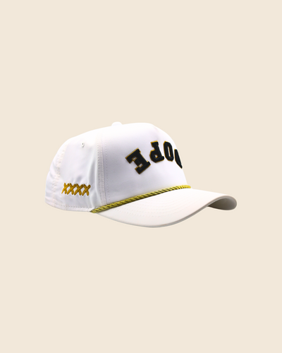 White Dope x Reversed hat at a three-quarter angle with gold side stitching