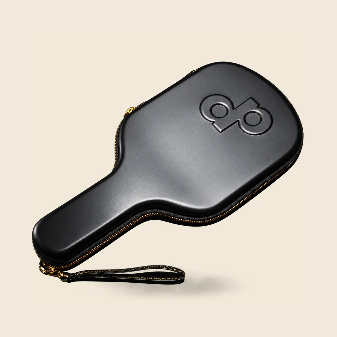 Black High Roller travel case angled with its head upper-right and handle lower-left, fully framed with matching paddle presentation.