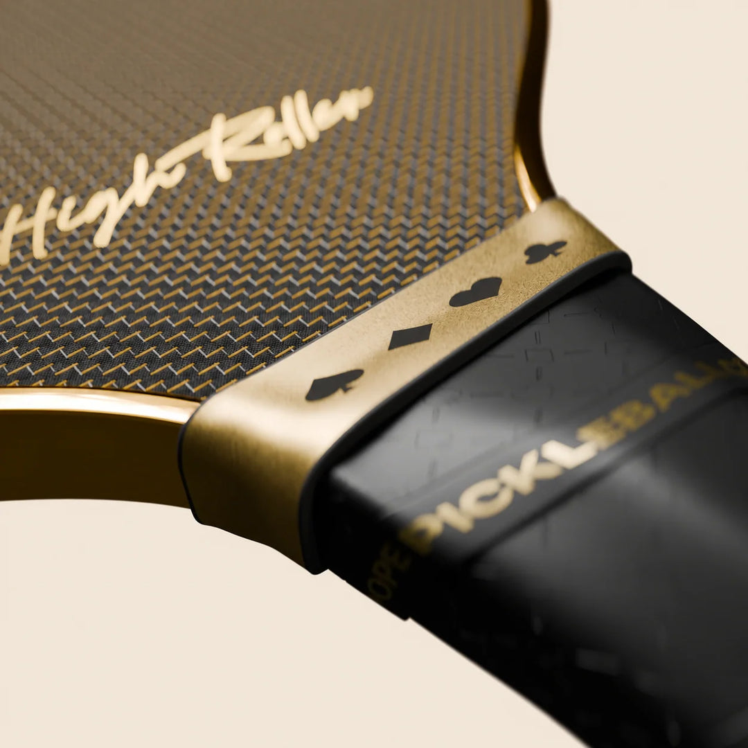 High Roller pickleball paddle studio close-up of script, patterned face and gold card-suit collar