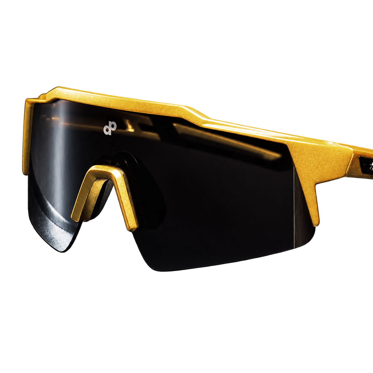 Close-up of High Roller sunglasses with their continuous black shield lens, angular gold frame and small white DP mark on a transparent background.