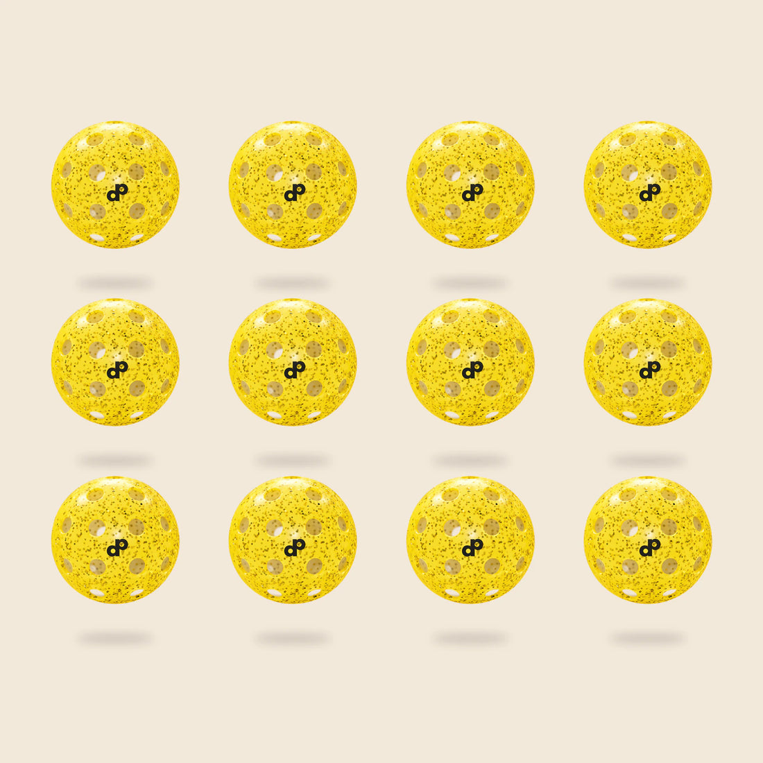 12 yellow DOPE glitter pickleballs, each with its black DP logo and original circular-hole layout, floating on cream.
