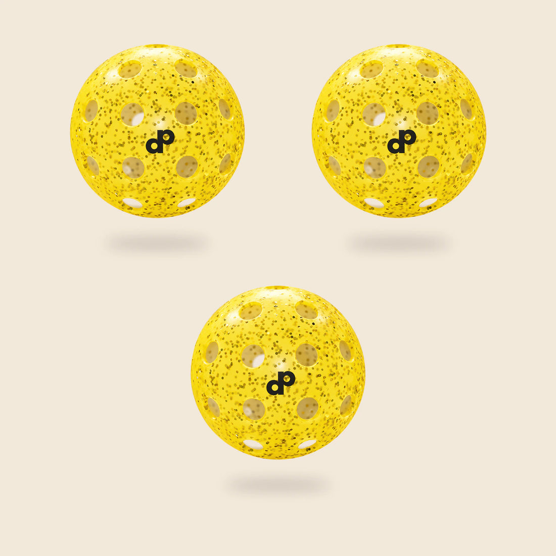 3 yellow DOPE glitter pickleballs, each with its black DP logo and original circular-hole layout, floating on cream.