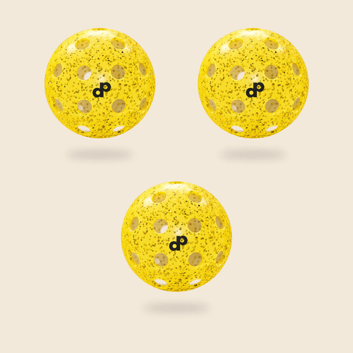 3 yellow DOPE glitter pickleballs, each with its black DP logo and original circular-hole layout, floating on cream.