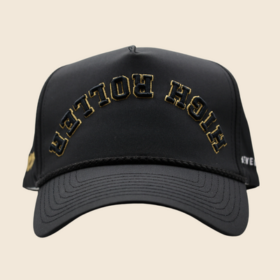 Front view of a black High Roller hat with gold lettering
