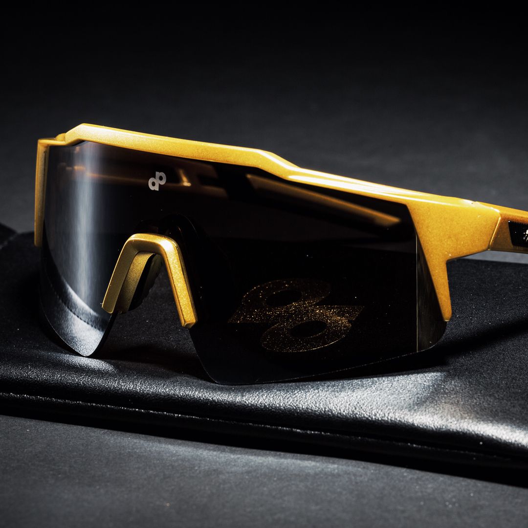 A photo of the Black and Gold colored plastic High Roller Sunglasses from Dope Pickleball Co. and custom leatherette case.