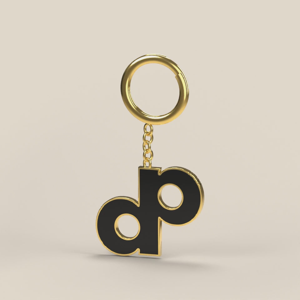 A rendered turn of the High Roller gold-tone and black enamel DOPE logo keychain.