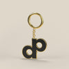 A rendered turn of the High Roller gold-tone and black enamel DOPE logo keychain.