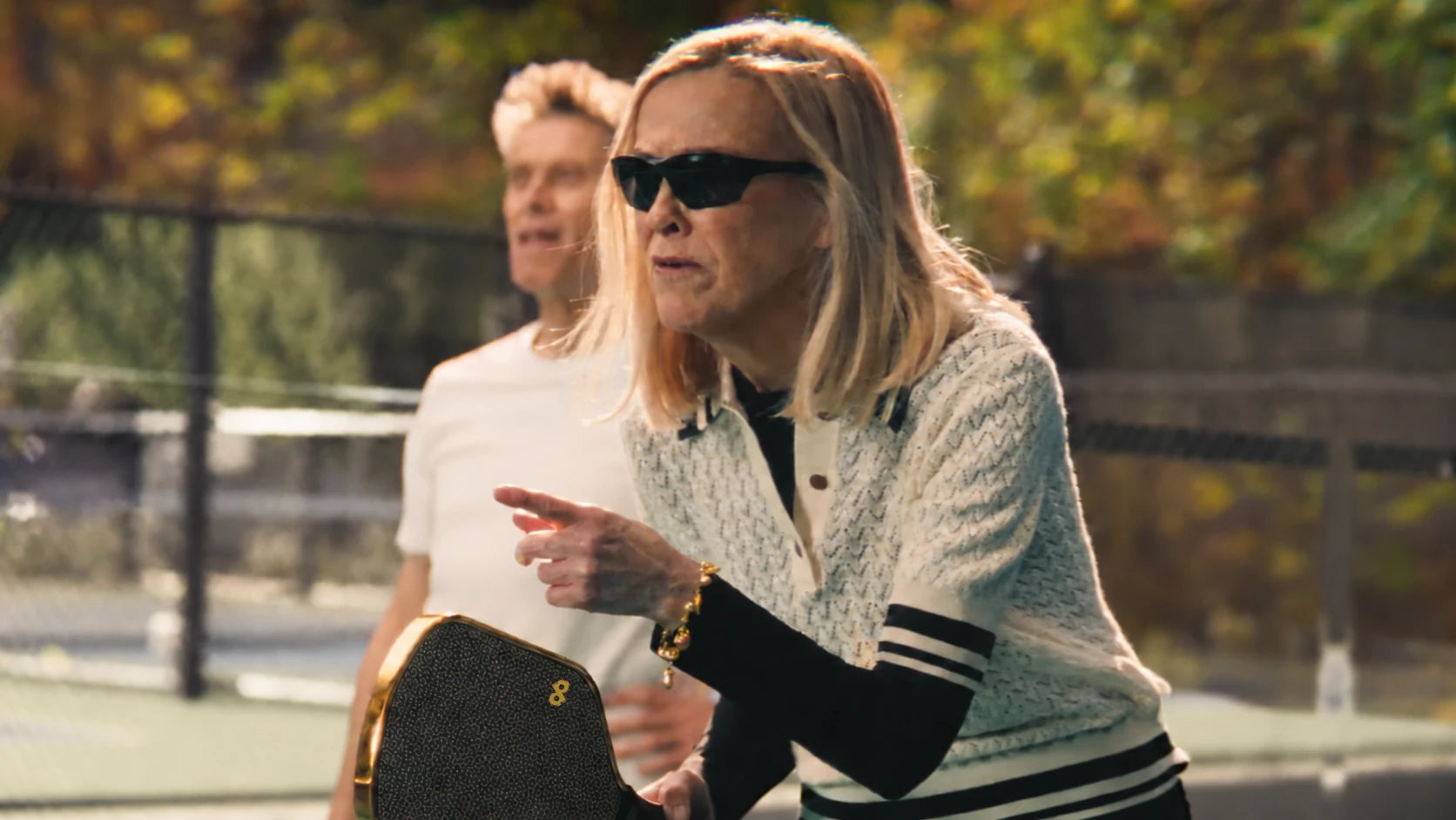 Catherine O’Hara pointing on court with the DOPE High Roller face print and small corner DP restored on her paddle.